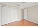 Bedroom showcasing a closet, ceiling fan, wood floors, and a connecting door at 2104 Gerardo Ave, The Villages, FL 32159