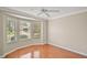 Bright bedroom with bay windows, wood floors, and a ceiling fan at 2104 Gerardo Ave, The Villages, FL 32159
