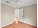 Bedroom showcasing a ceiling fan, wood floors, and a connecting door at 2104 Gerardo Ave, The Villages, FL 32159