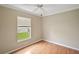 Bedroom with a window offering natural light and wood floors at 2104 Gerardo Ave, The Villages, FL 32159