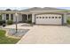 Charming single story home featuring a two car garage and well-manicured landscaping at 2104 Gerardo Ave, The Villages, FL 32159
