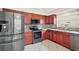 Well-appointed kitchen featuring stainless steel appliances and dark wood cabinetry at 2104 Gerardo Ave, The Villages, FL 32159