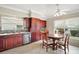 Eat-in kitchen featuring stainless steel appliances, granite countertops, and wood cabinetry at 2104 Gerardo Ave, The Villages, FL 32159
