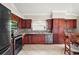 Modern kitchen boasting stainless steel appliances, granite countertops, and dark wood cabinetry at 2104 Gerardo Ave, The Villages, FL 32159