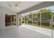 Enclosed lanai featuring white floors, screened walls, and a ceiling fan at 2104 Gerardo Ave, The Villages, FL 32159