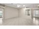 Open-concept living room with tile floors, ceiling fan, and a glimpse of the front entrance at 2104 Gerardo Ave, The Villages, FL 32159