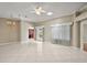 Sunlit living room featuring tile floors, ceiling fan, and sliding glass doors to the patio at 2104 Gerardo Ave, The Villages, FL 32159
