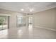 Spacious living room with tile flooring, a ceiling fan, and sliding glass doors leading to the outdoors at 2104 Gerardo Ave, The Villages, FL 32159