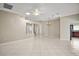 Expansive living room with tile flooring, ceiling fan, and view into the kitchen at 2104 Gerardo Ave, The Villages, FL 32159