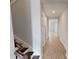 Hallway with wood-look floors leads to bedrooms and living spaces, with stairs to the left at 2153 Axel St, Minneola, FL 34715