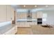 Modern kitchen featuring white cabinets, stainless steel appliances, and granite countertops at 2153 Axel St, Minneola, FL 34715