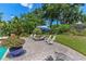 The back of the property, showing a brick patio and a lawn with chairs and an umbrella at 2214 Dogwood Cir, Mount Dora, FL 32757