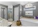 Luxurious bathroom features a soaking tub, walk-in shower, and vanity at 2214 Dogwood Cir, Mount Dora, FL 32757