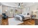 Bright bedroom featuring a large bed, wood floors and natural lighting at 2214 Dogwood Cir, Mount Dora, FL 32757