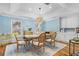 Bright dining room features stylish light fixture, blue walls, and wood floors at 2214 Dogwood Cir, Mount Dora, FL 32757