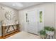 Welcoming foyer with hardwood floors, decor, and a front door with sidelights at 2214 Dogwood Cir, Mount Dora, FL 32757