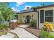 Charming entryway with a dark front door, complemented by planters and decorative accents at 2214 Dogwood Cir, Mount Dora, FL 32757
