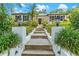 View up walkway to the front door, flanked by elegant lanterns and vibrant landscaping at 2214 Dogwood Cir, Mount Dora, FL 32757