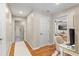 Hallway featuring hardwood floors leading to bedrooms and play area at 2214 Dogwood Cir, Mount Dora, FL 32757