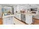 Spacious kitchen with stainless steel appliances, modern cabinets, and an open floor plan to the living area at 2214 Dogwood Cir, Mount Dora, FL 32757