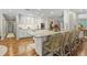 Well-lit kitchen featuring white cabinets, granite countertops, stainless steel appliances, and a breakfast bar at 2214 Dogwood Cir, Mount Dora, FL 32757