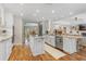 Bright kitchen featuring stainless steel appliances, hardwood floors, and a view into the living room at 2214 Dogwood Cir, Mount Dora, FL 32757
