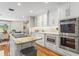 Spacious kitchen featuring stainless appliances, stone countertops, and access to the dining room at 2214 Dogwood Cir, Mount Dora, FL 32757