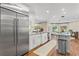 Contemporary kitchen with stainless steel refrigerator, granite countertops and modern appliances at 2214 Dogwood Cir, Mount Dora, FL 32757