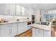 Kitchen with white cabinets, stainless appliances, stone countertops, and a modern backsplash at 2214 Dogwood Cir, Mount Dora, FL 32757