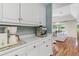 Kitchenette features white cabinets, light countertops, and wood flooring at 2214 Dogwood Cir, Mount Dora, FL 32757