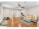 Bright living room boasts hardwood floors, a ceiling fan and comfortable neutral colored furniture at 2214 Dogwood Cir, Mount Dora, FL 32757