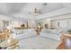 Spacious living room featuring hardwood floors, ample seating, and seamless flow to other living areas at 2214 Dogwood Cir, Mount Dora, FL 32757