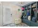 Mud room with custom shelving, storage, and a white wooden bench by the entry door at 2214 Dogwood Cir, Mount Dora, FL 32757