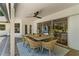 Covered patio includes a table, dining chairs, and ceiling fan overlooking the backyard and pool at 2214 Dogwood Cir, Mount Dora, FL 32757