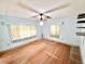 Bedroom with hardwood floors, a ceiling fan, bright natural light, and storage shelves at 2237 Washington Rd, Mount Dora, FL 32757