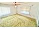 Bedroom with a ceiling fan, carpet and bright, natural light from the windows at 2237 Washington Rd, Mount Dora, FL 32757