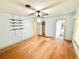 Bedroom with hardwood floors, storage shelves, a ceiling fan and doorways into other rooms at 2237 Washington Rd, Mount Dora, FL 32757