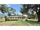 Quaint single-story home with mature trees, a neatly kept lawn, and inviting curb appeal at 2237 Washington Rd, Mount Dora, FL 32757