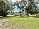 Expansive front yard showcasing the home's position on a large, grassy lot with mature trees at 2237 Washington Rd, Mount Dora, FL 32757
