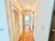 Hallway with wood flooring, a ceiling light and doorways into other rooms at 2237 Washington Rd, Mount Dora, FL 32757