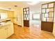 Open kitchen with retro cabinets and appliances, complemented by a view into the spacious living room at 2237 Washington Rd, Mount Dora, FL 32757