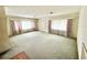 Spacious living room featuring large windows and a neutral carpet, awaiting personalization at 2237 Washington Rd, Mount Dora, FL 32757