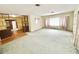 Open-concept living room with a partial divider leading to the kitchen, offering an airy atmosphere at 2237 Washington Rd, Mount Dora, FL 32757