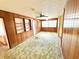 Cozy sunroom with wood paneling and vintage carpet, perfect for relaxation and hobbies at 2237 Washington Rd, Mount Dora, FL 32757