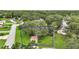 Aerial view of a landscaped home with mature trees on a large lot at 24 Brigadoon Cir, Leesburg, FL 34788