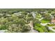 A serene, scenic aerial view of the neighborhood, full of lush greenery and verdant lawns at 24 Brigadoon Cir, Leesburg, FL 34788