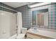 Bathroom with tub and shower combination, single sink vanity, and patterned wallpaper at 24 Brigadoon Cir, Leesburg, FL 34788