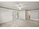 Spacious bedroom with sliding glass doors and a ceiling fan at 24 Brigadoon Cir, Leesburg, FL 34788