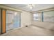 Bright carpeted bedroom with a sliding glass door and large window for natural light at 24 Brigadoon Cir, Leesburg, FL 34788