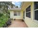 The exterior of the house features a red brick patio and yellow siding at 24 Brigadoon Cir, Leesburg, FL 34788